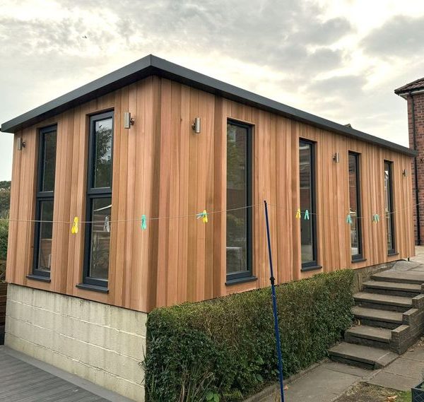 6m x 3m bespoke overhang studio with fixed full height windows, side opening windows and outside lights