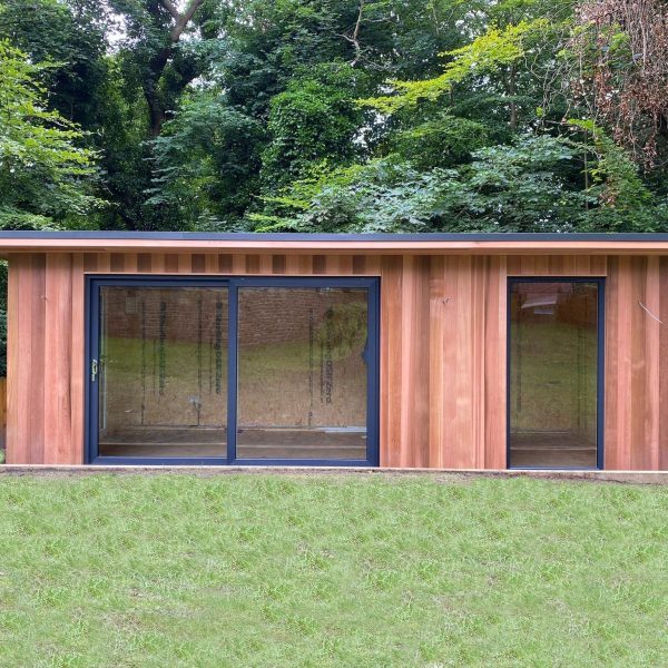 6.6m x 3m bespoke studio with UPVC sliding doors and full height fixed window