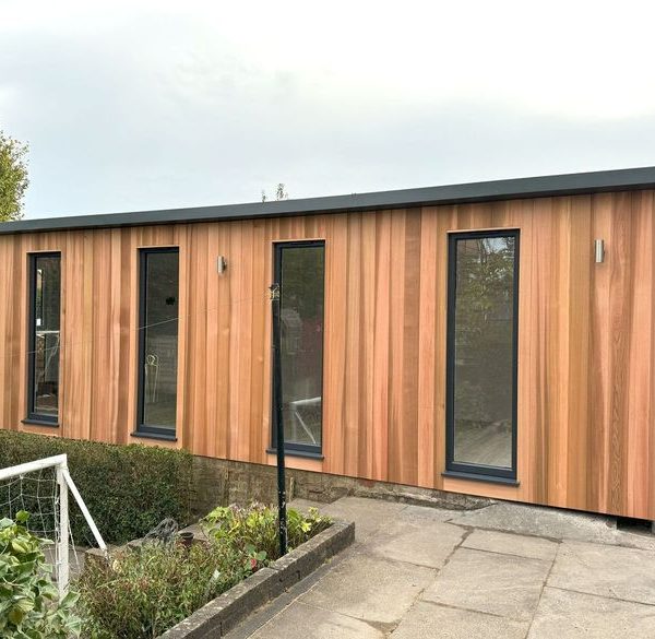 6.8m x 3.5m bespoke overhang studio with fixed full height windows and outside lights