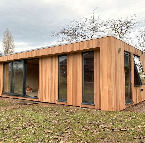 7.2m x 3.5m bespoke cubed studio with side cheeks, aluminium bifolding doors, fixed full height windows, opening window and outside lights