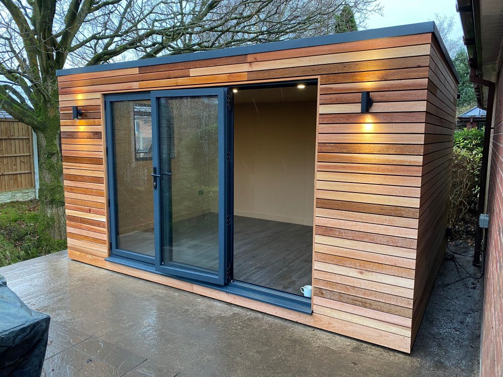4.2m x 3m bespoke cubed studio with aluminium bifolding doors, side opening window and outside lights
