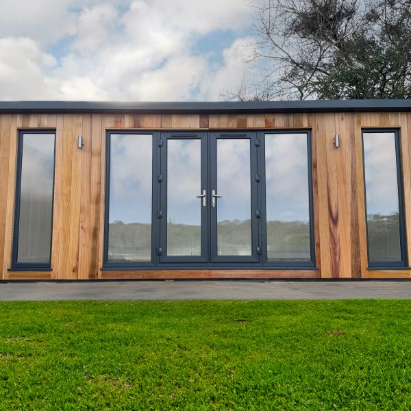 bespoke build with French doors, side lights and additional fixed full height windows